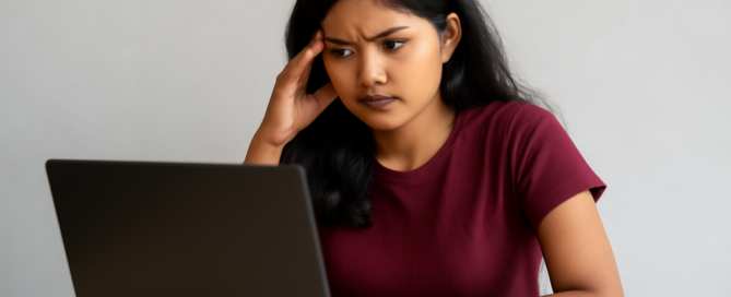 A girl is reading ignou mba project guide on her laptop
