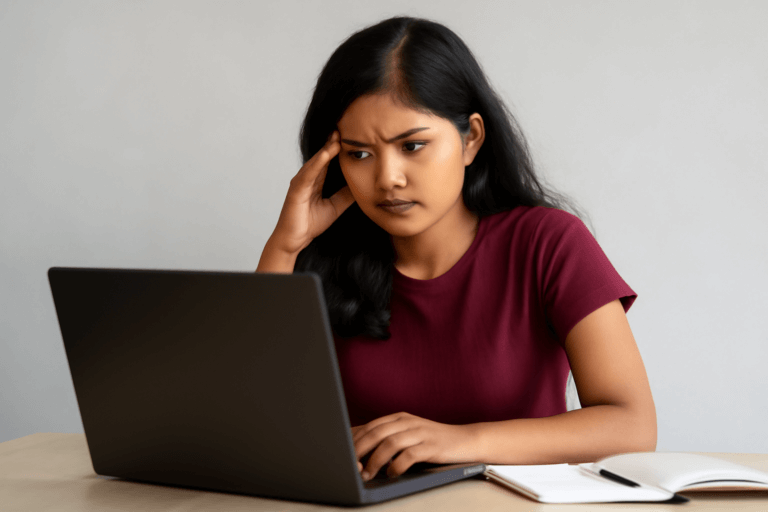 A girl is reading ignou mba project guide on her laptop