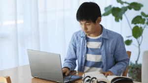 student working on his project topic of mcom